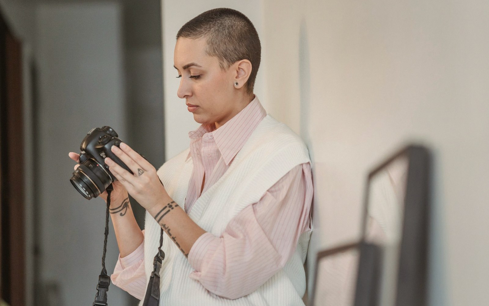 A photographer checking a camera back in a doorway
